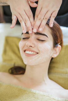 Young woman receiving facial beauty treatment in a spa - LJF00853