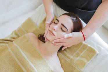 Young woman receiving facial beauty treatment in a spa - LJF00856