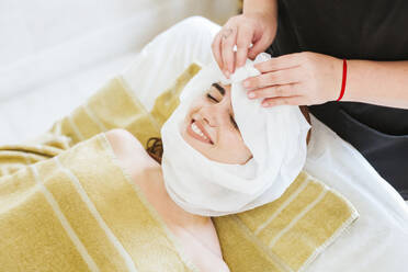 Young woman receiving facial beauty treatment in a spa - LJF00857