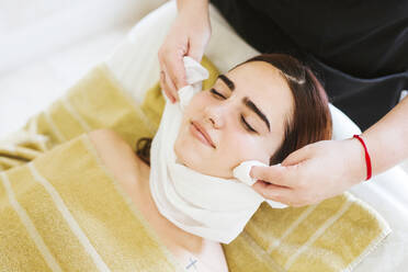 Young woman receiving facial beauty treatment in a spa - LJF00858