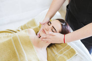 Young woman receiving facial beauty treatment in a spa - LJF00860