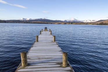 Frost covered jetty at the north end of Windermere near Ambleside, with rugged snow covered mountains including Helvellyn, Lake District National Park, UNESCO World Heritage Site, Cumbria, England, United Kingdom, Europe - RHPLF04746