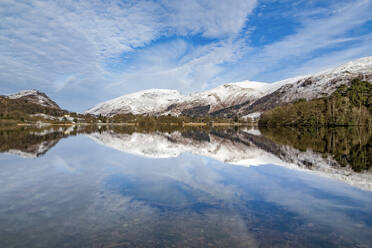 A perfect reflection of snow covered mountains and dramatic sky in the still waters of Grasmere, Lake District National Park, UNESCO World Heritage Site, Cumbria, England, United Kingdom, Europe - RHPLF04752
