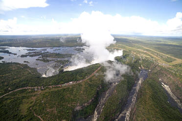 Mist rises above the Victoria Falls waterfall (Mosi-oa-Tunya), UNESCO World Heritage Site on the border of Zimbabwe and Zambia, Africa - RHPLF04763