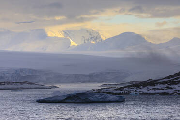 Sunrise, over misty mountains and tidewater glaciers, Anvers Island, Antarctic Peninsula, Antarctica, Polar Regions - RHPLF05511