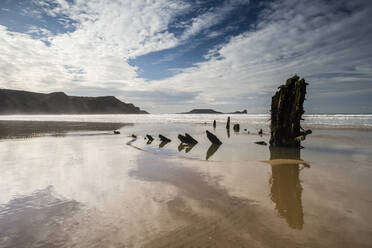 Helvetia shipwreck and clouds reflected in wet sand, at low tide, Rhossili Bay, Gower Peninsula, South Wales, United Kingdom, Europe - RHPLF05732