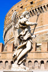 An angel statue from Ponte Sant'Angelo with Castle of the Holy Angel (Castel Sant'Angelo), Rome, Lazio, Italy, Europe - RHPLF05772