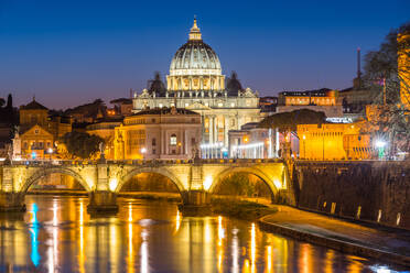 St. Peters Basilica and the Vatican with Ponte St Angelo over river Tiber illuminated at dusk, Rome, Lazio, Italy, Europe - RHPLF05778