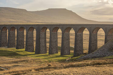 View to Ingleborough and the arches of Ribblehead Viaduct on the Settle to Carlisle railway line, Yorkshire Dales, North Yorkshire, England, United Kingdom, Europe - RHPLF05849