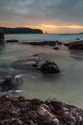 Rock formations at Sandwood Bay, with Am Buachaille sea stack in far distance, Sutherland, Scotland, United Kingdom, Europe - RHPLF06503