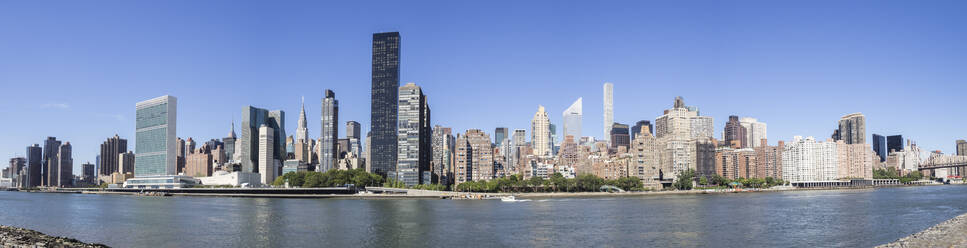 Panoramablick auf die Skyline von Manhattan mit UN, Empire State Building und Matchstick Building von Roosevelt Island, New York, Vereinigte Staaten von Amerika, Nordamerika - RHPLF06709