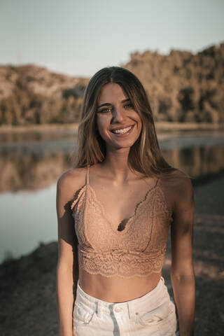 Young blond woman at a lake stock photo