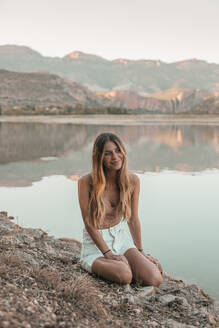 Young blond woman at a lake - ACPF00620