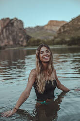 Young blond woman bathing in a lake in summer, in the evening - ACPF00622