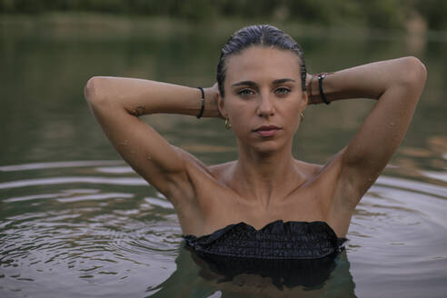 Portrait of young blond woman bathing in a lake - ACPF00624