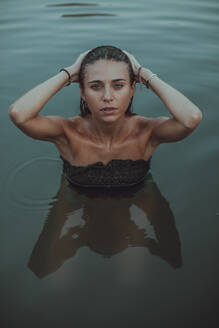 Portrait of young blond woman bathing in a lake - ACPF00625