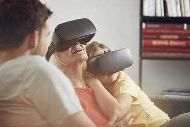 Grandmother using VR glasses with her grandsons - MCF00259