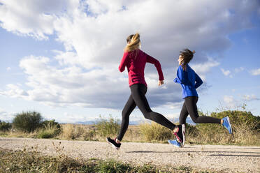 Two Women Running In Park Stock Photo, Picture and Royalty Free Image.  Image 74107441.