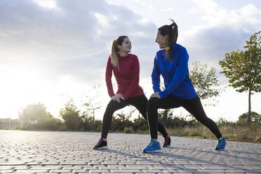 Women stretching her legs in the park - ABZF02546