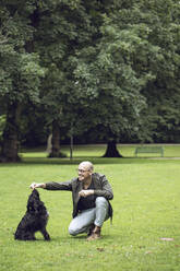 Man and his dog in a park - MCF00266