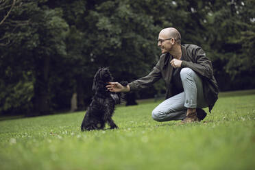 Man and his dog in a park - MCF00267