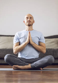 Man doing yoga at home - MCF00303