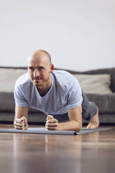 Man doing gymnastics at home - MCF00304