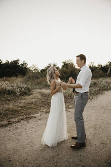Affectionate bride and groom in the countryside - LHPF00763