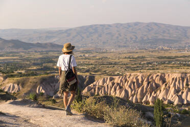 Woman walking to viewpoint near Uchisar, Cappadocia, Turkey - KNTF03311