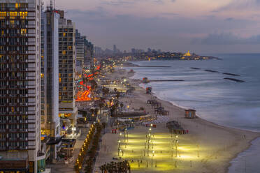 Elevated view of the beaches and hotels at dusk, Jaffa visible in the background, Tel Aviv, Israel, Middle East - RHPLF07069