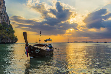 A long tail boat at sunset on Railay beach in Railay, Ao Nang, Krabi Province, Thailand, Southeast Asia, Asia - RHPLF07358