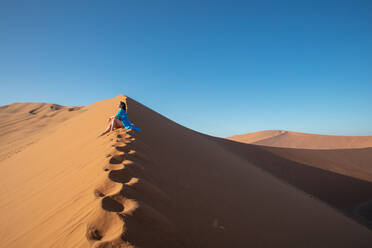 Model climbing Dune 13, Sossusvlei, Namibia, Africa - RHPLF07381