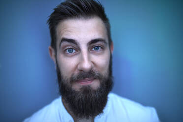 Portrait of bearded man in blue light - ZEDF02575