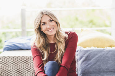 Happy woman relaxing at home stock photo