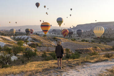 Junge Frau und Heißluftballons, Goreme, Kappadokien, Türkei - KNTF03319