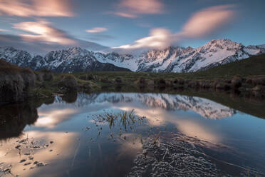 Snowy peaks and pink clouds reflected in water at dawn, Tombal, Soglio, Bregaglia Valley, canton of Graubunden, Switzerland, Europe - RHPLF07460