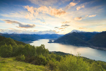 Lake Como surrounded by green meadows framed by pink sky at dawn, Cremia, San Domenico, Lombardy, Italian Lakes, Italy, Europe - RHPLF07463