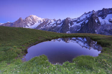 Twilight illuminates Mont Blanc, Mont de la Saxe, Ferret Valley, Courmayeur, Aosta Valley, Italy, Europe - RHPLF07591