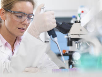 DNA Research, Scientist pipetting a DNA sample into a tube ready for automated analysis in the laboratory - ABRF00558