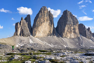 Rear view of boy with arms raised standing in front of Tre Cime Di Lavaredo, Italy - LOMF00885