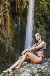 Young woman posing at a waterfall - LJF00909