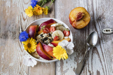 High angle view of breakfast and flowers on wooden table - EVGF03456