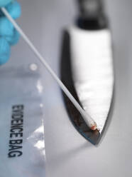 Gerichtsmedizinerin nimmt DNA-Beweise von einem blutverschmierten Messer auf - ABRF00604