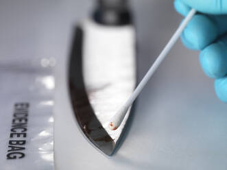 Gerichtsmedizinerin nimmt DNA-Beweise von einem blutverschmierten Messer auf - ABRF00606
