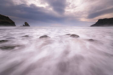 Scenic view of Talisker Beach against cloudy sky during sunset, Scottish Highlands, Scotland, UK - SMAF01426