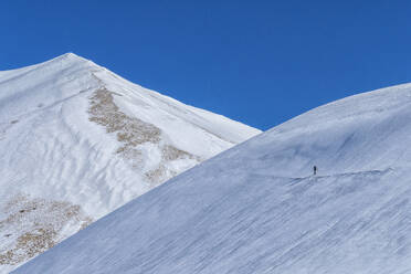 Hiker on mountain Vettore in winter, Sibillini National Park, Umbria, Italy, Europe - RHPLF08028