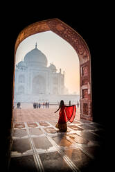 A lady twirls as the sun rises behind the Taj Mahal, UNESCO World Heritage Site, Agra, Uttar Pradesh, India, Asia - RHPLF08511