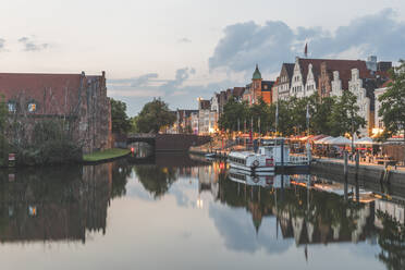 Ship moored by Trave River against sky during sunset, Lübeck, Germany - KEBF01328