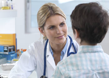 Female doctor reassuring a patient during an appointment in the clinic - ABRF00626