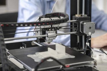 Student setting up 3D printer, close up - VPIF01459